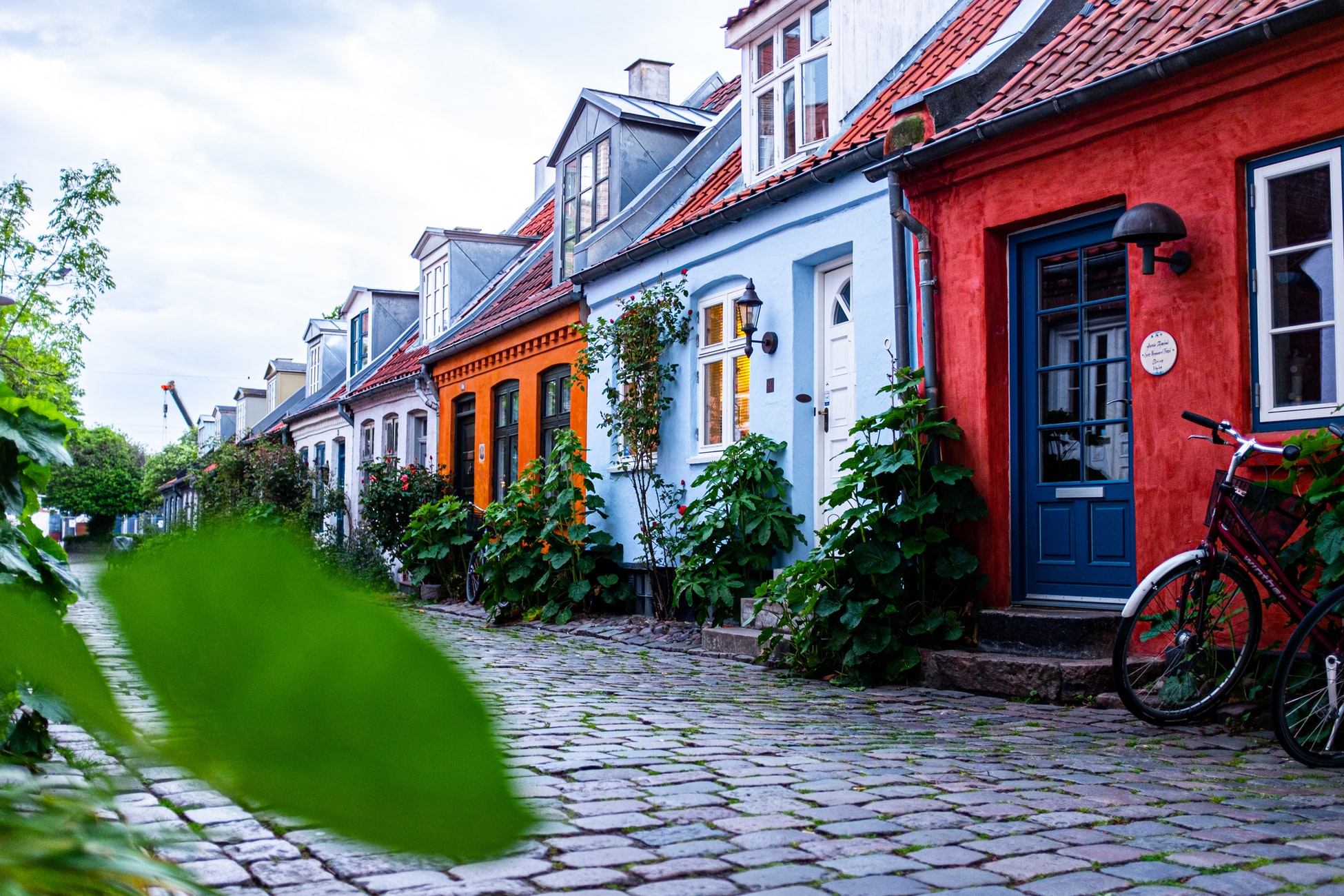 row of colourful houses along cobblestone street