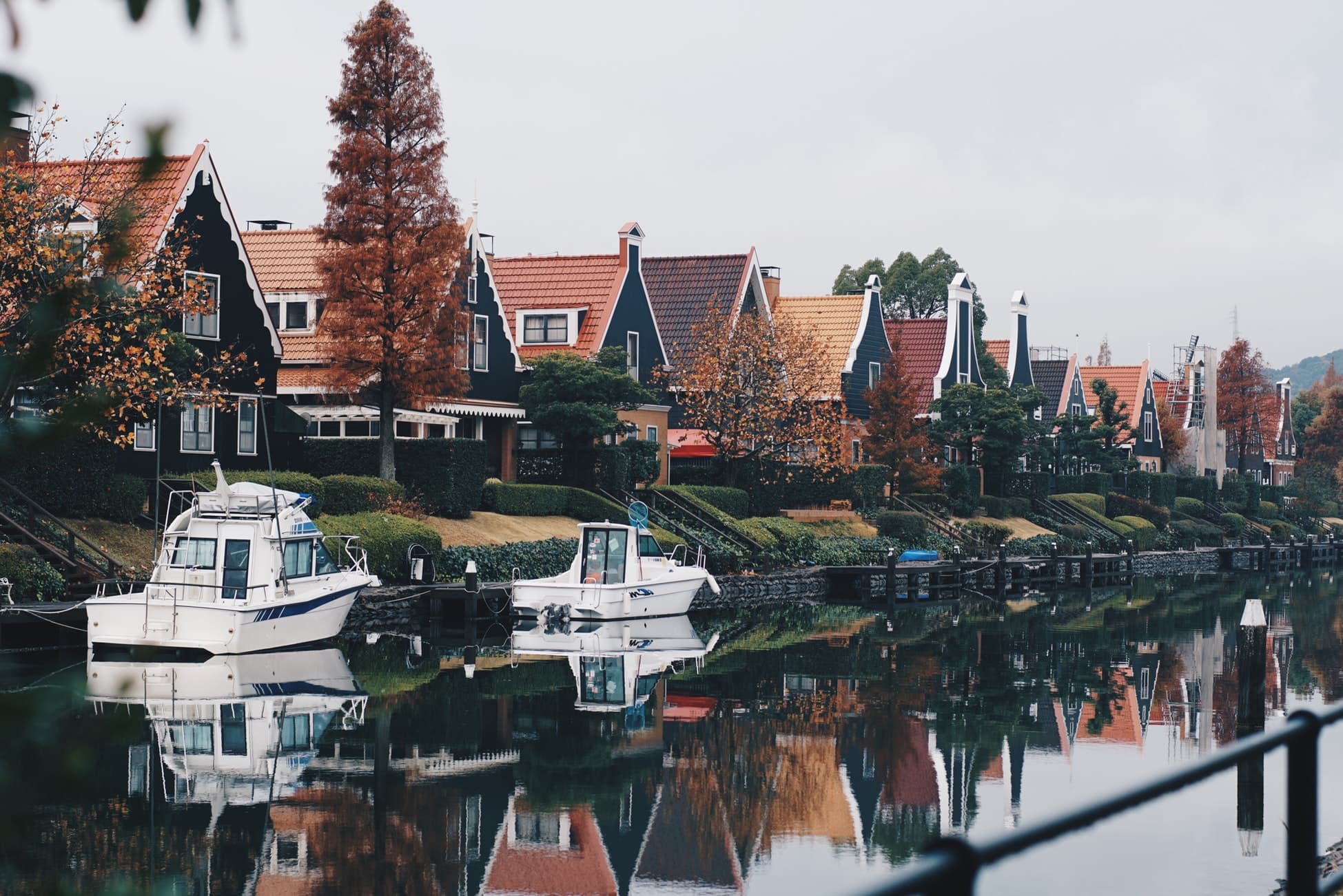 row of houses along canal with boats