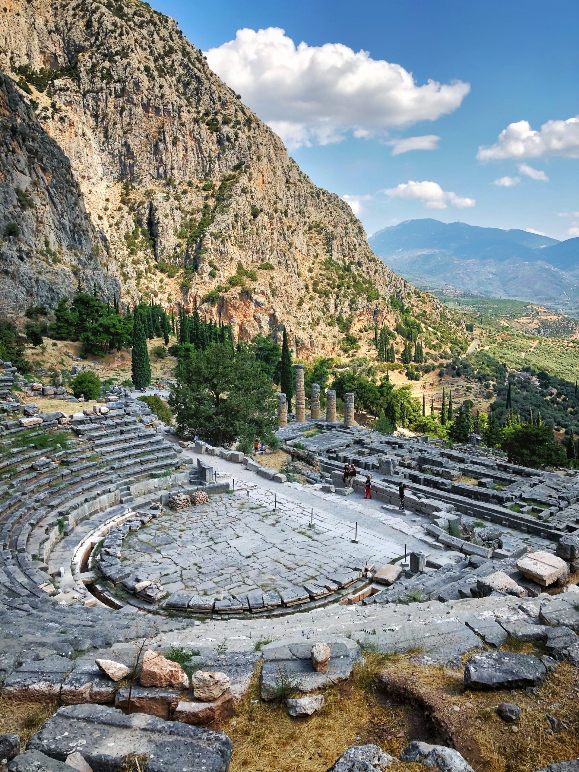theatre ruins surrounded by cliffs mountains