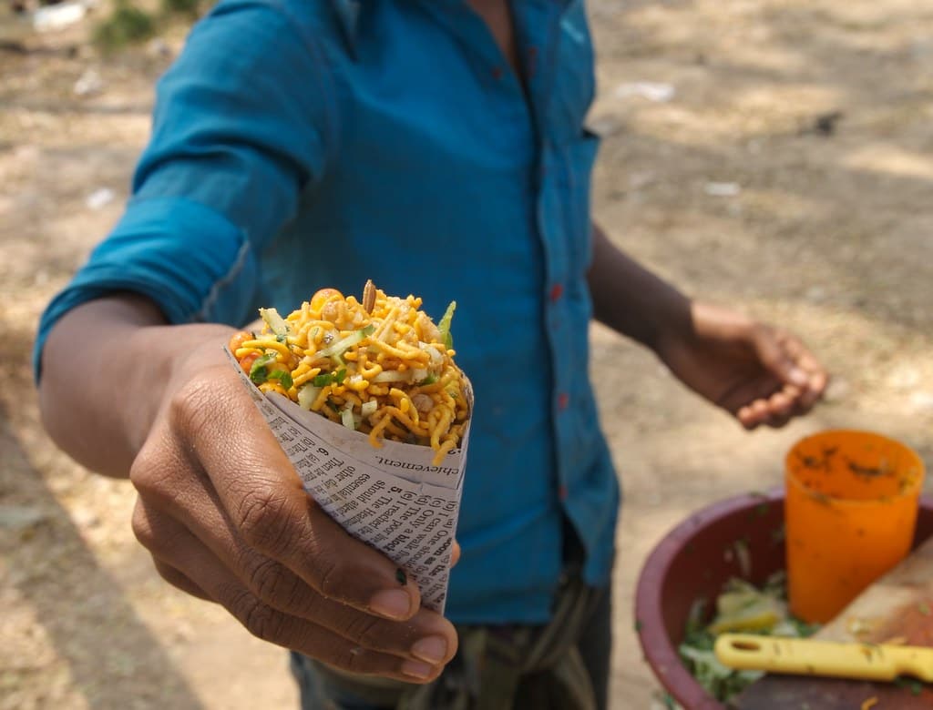 The completed sstreet-food-bangladeshnack, in a newspaper cone.