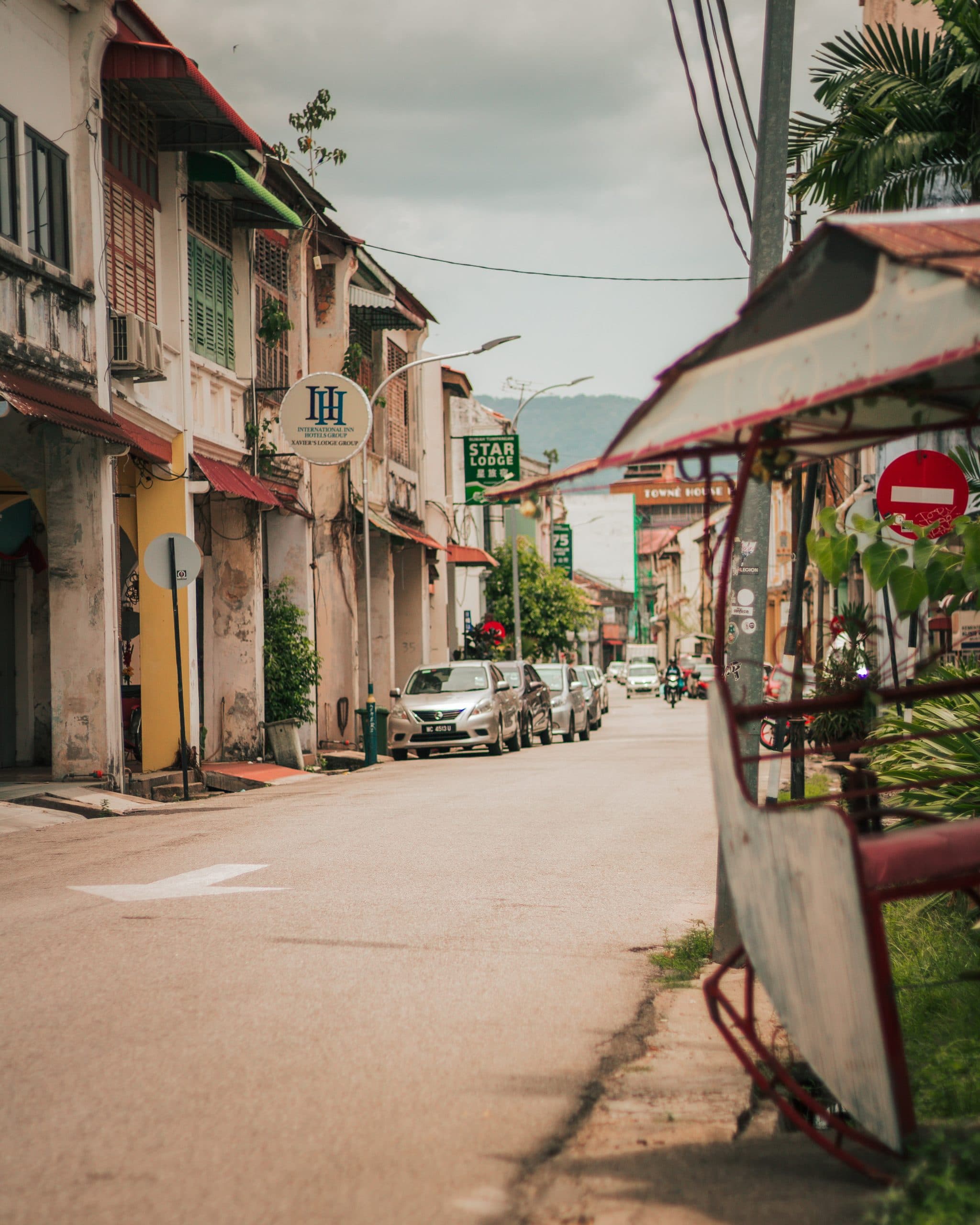 street with parked cars and old buildings