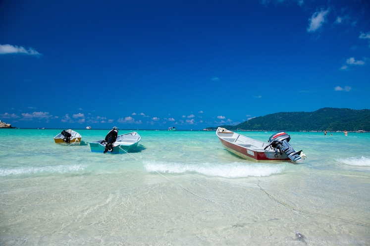 Boats get ready to sail into the blue of The Perhentian Islands