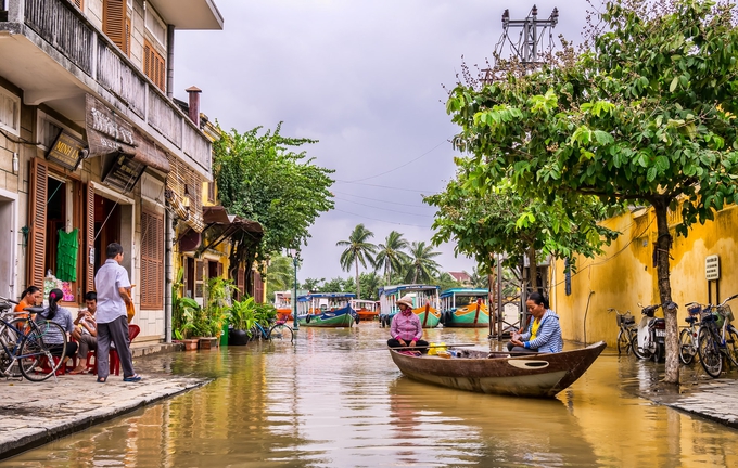 two women riding boat on river hoi an