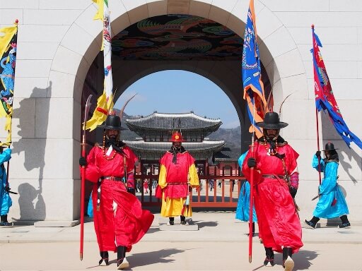 three palace guards in red uniform seoul