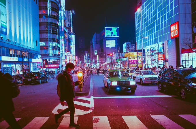 man crossing street at night osaka